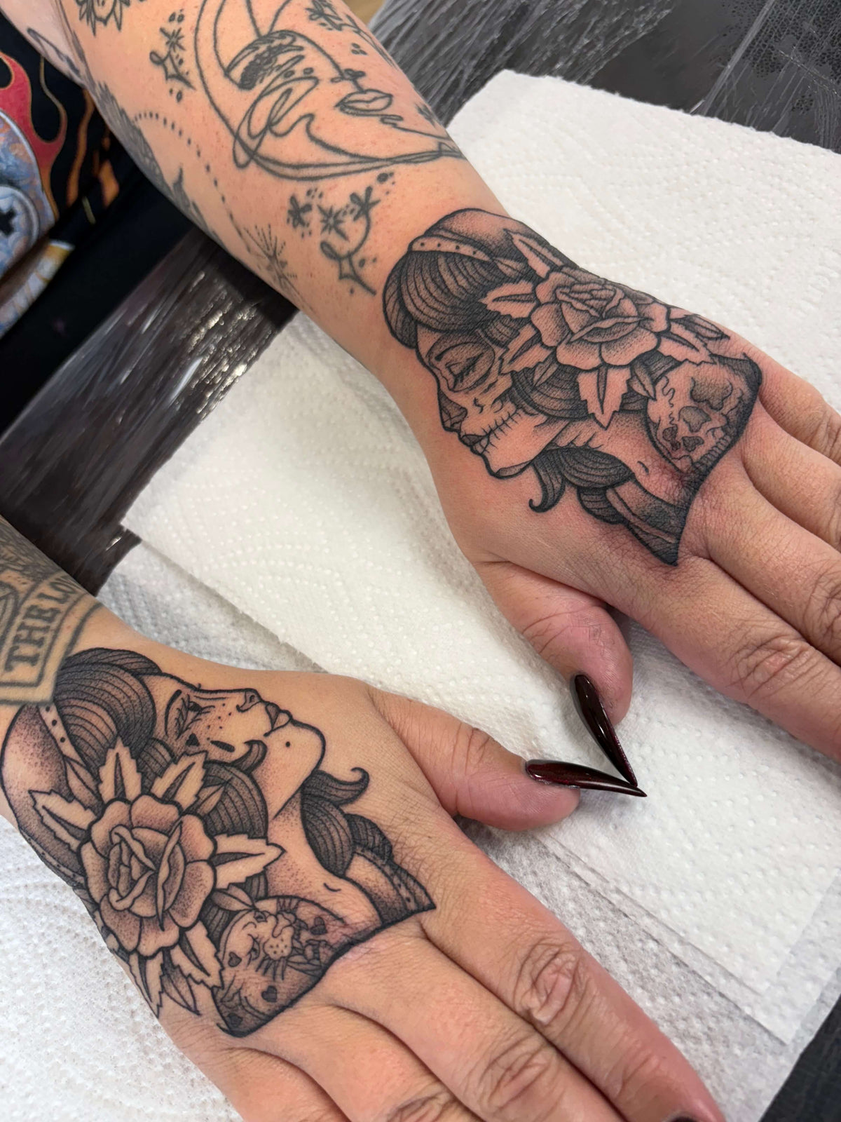 traditional style woman face with roses hand tattoos
delboitattooks