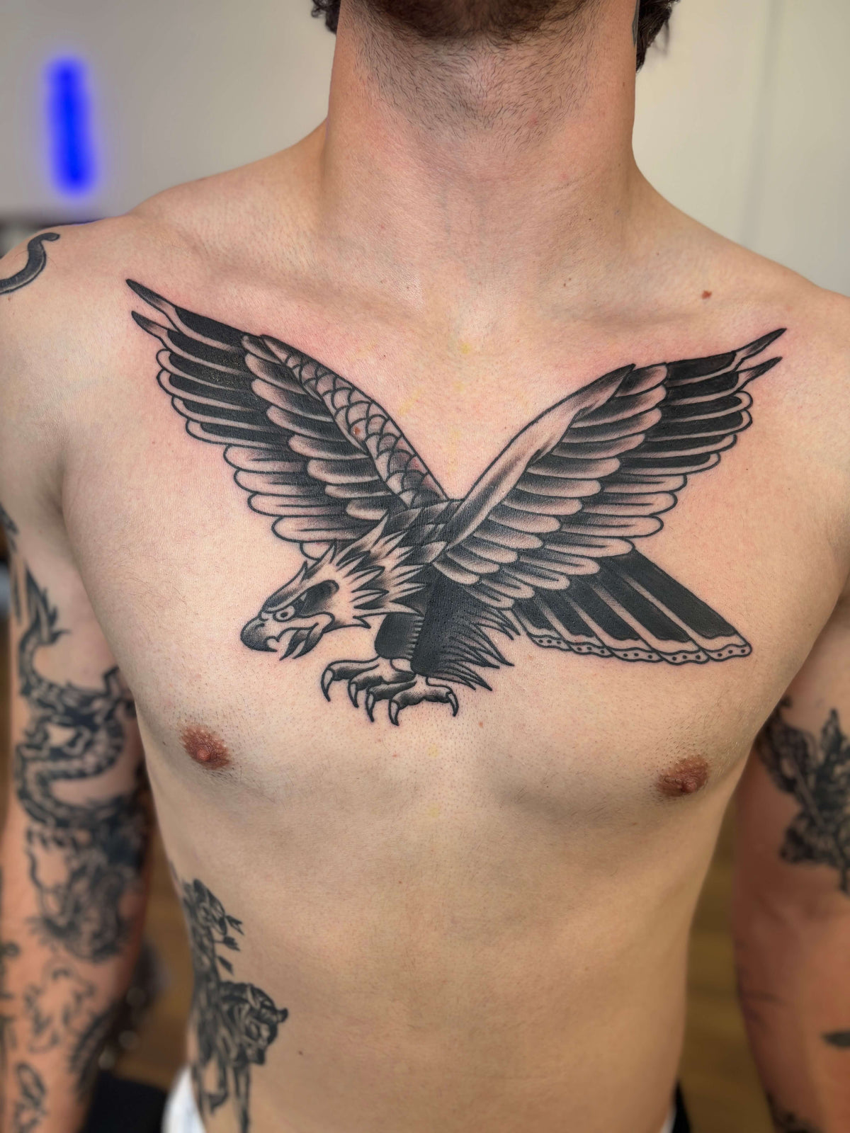 traditional blackwork eagle tattoo on a chest
delboitattoos