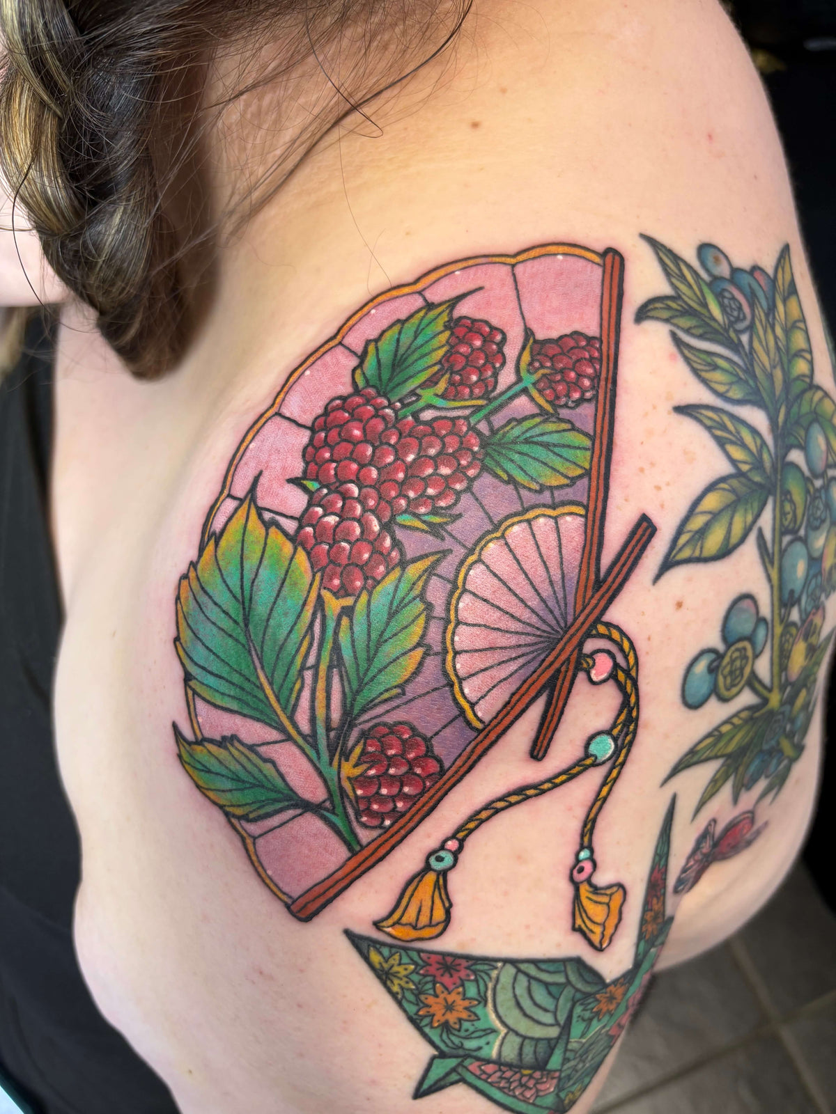 colour Japanese style fan tattoo with berries
delboitattoos